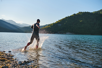 Image showing Triathlon athlete starting swimming training on lake