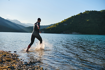 Image showing Triathlon athlete starting swimming training on lake