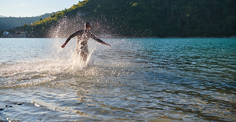 Image showing Triathlon athlete starting swimming training on lake