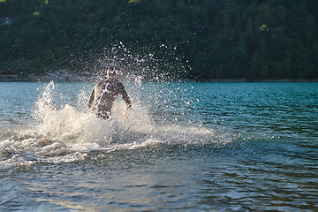 Image showing Triathlon athlete starting swimming training on lake