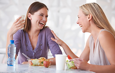 Image showing Laughing, colleagues or friends at lunch in cafeteria with funny conversation, smile and eating. Healthy food, drinks and happy women in cafe for gossip, bonding and employees in break room together.