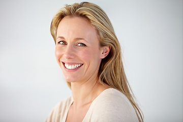 Image showing Portrait, smile and mature woman in studio with confident personality isolated on white background. Face of beautiful blond model in good mood, pride and happy to relax for optimism in New Zealand