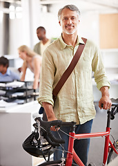 Image showing Mature, businessman and bicycle in office with portrait and manager of sustainable company. Ceo, boss and job with eco friendly commute in morning with smile in a creative agency of a professional