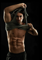 Image showing Portrait, black background or man undress with six pack, strong abs or stomach in studio for fitness. Off, cool model or ripped person with healthy body, dark shadow or abdomen muscle for wellness