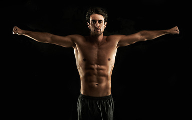 Image showing Arms raised, black background or topless man for workout, training or exercise in studio for fitness. Model, dark shadow or ripped male person with healthy body, six or stomach for wellness in Italy