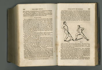 Image showing Old book, vintage and fitness guide of antique manuscript, scripture or ancient literature on exercises against a studio background. Closeup of historical novel, journal or classic workout history