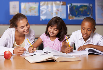 Image showing Teacher, books and school kids in classroom, writing or learning together for development, studying or knowledge. Woman, children and help with notebook with support, teaching or education with smile