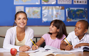 Image showing Teacher, portrait and school kids in classroom, books and learning together for development, studying or writing notes. Woman, children and notebook with support, teaching and education with smile