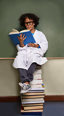 Image showing Child, classroom and reading books for school, science learning and physics knowledge on chalkboard and stack. Smart kid or african student in glasses with library resources and textbook for language
