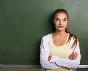 Image showing Teacher woman, portrait and chalkboard with space for mockup, classroom or learning for future at academy. Education employee, teaching expert or person with promo, knowledge or information in school