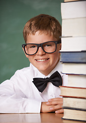 Image showing Boy kid, smile and portrait with books, classroom and learning for exam, assessment and studying for knowledge. Student child, notebook and happy for education, development and glasses by chalkboard