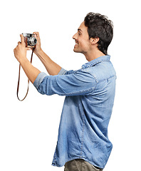 Image showing Selfie, smile and retro camera with a man in studio isolated on a white background for photography. Profile, hobby and vintage technology with a happy young photographer posing for a picture