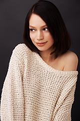 Image showing Shy, sweater and woman on dark background for fashion, winter style and trendy clothes. Natural beauty, shoulder and face of attractive person in jersey for cozy, comfort and warm clothing in studio