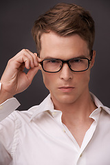 Image showing Serious, man and confident portrait with glasses, fashion or choice in eyewear on dark background of studio. Check, optometry and geek with spectacles, style and person with prescription lenses