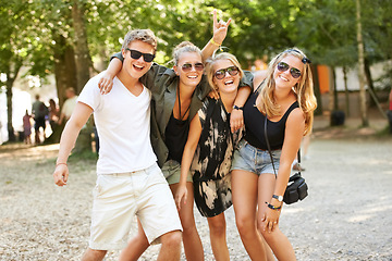 Image showing Hug, celebration and friends at a park for festival, concert or happy social gathering. Face, fun and people in a forest with freedom, energy and excited for event, reunion or party with rocker hands