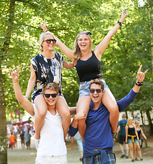 Image showing Couple of friends, carrying and woman on shoulders at music festival, celebration and cheers of fans. Happy, people or rock n roll portrait at social event or men support girlfriends for fun games