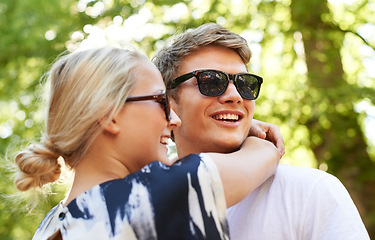 Image showing Love, hug and happy couple in a park with conversation, support and vacation freedom. Travel, care and people embrace in a forest for summer, romance or bond, speaking or adventure in nature together