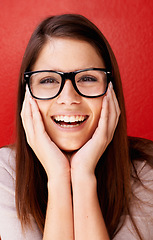 Image showing Portrait, glasses and face of happy woman with smile for style or sight against a red studio background. Young friendly female person, nerd or geek in happiness, excited or fashion with eyewear