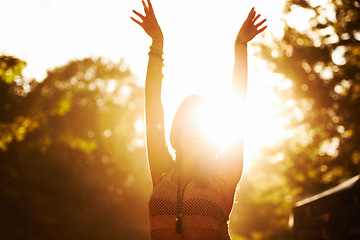 Image showing Woman, sunset and outdoor festival for party, event or holiday weekend with arms up in nature freedom. Excited casual female person in celebration for music, concert or sunrise in forest outside