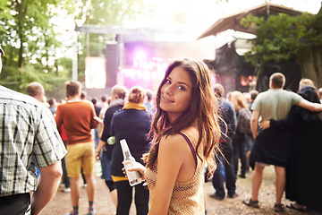 Image showing Woman, portrait and drink at outdoor music festival with crowd for party or event in nature. Face of female person smile and enjoying sound or audio at carnival, concert or performance outside