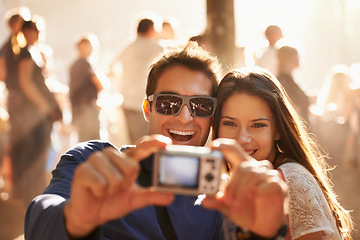 Image showing Happy couple, camera and selfie at music festival for memory, photography or picture in outdoor crowd. Excited man and woman smile for photograph, photo or capture at party, carnival or summer fest