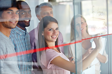 Image showing Happy woman, team and writing on glass board for schedule planning, meeting or creative strategy at office. Portrait of employee group smile in teamwork, collaboration or startup project at workplace