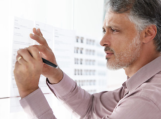 Image showing Senior businessman, writing and schedule planning on glass board for brainstorming or strategy at office. Closeup of mature man working on project plan, agenda or tasks for vision at workplace