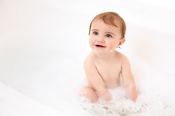 Image showing Baby in bath with soap, water and clean fun in home for skincare, wellness and hygiene. Bubble bathtub, foam and happy child in bathroom with cute face, care and washing body of dirt, germs and smile