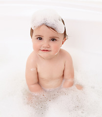 Image showing Baby in bath with soap, water and portrait of clean fun in for skincare, wellness and hygiene. Bubbles in bathtub, foam and child in bathroom with cute face, care and washing dirt, germs and smile.