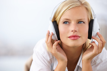 Image showing Woman thinking, relax and listening to music with audio streaming service and mental health podcast at home on bed. Young student or person with ideas, vision and headphones for sound and inspiration