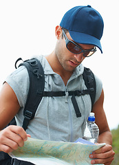 Image showing Map, hiking and man with nature, adventure and fitness with fresh air, location information and journey. Person, hiker and guy with documents for guidance, direction and travel with forest and lost