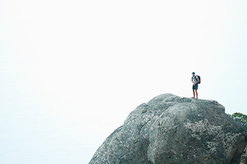 Image showing Peak, man and mountains in nature hiking with water, backpack and blue sky mockup space for workout, training and exercise. Hiker, person and fitness freedom for health, wellness and climbing sports