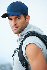 Image showing Portrait, hiking and man with nature, workout and exercise with wellness, fresh air or challenge. Person, hiker or guy with backpack, hobby or activity with freedom, training or endurance with face