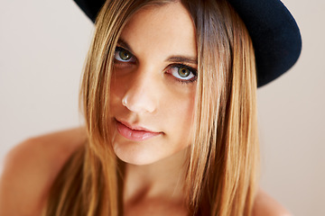 Image showing Serious, hipster and portrait of woman with vintage hat, fashion or confidence in white background or studio. Retro, style and face of person in old fashioned fedora with makeup, cosmetics and beauty