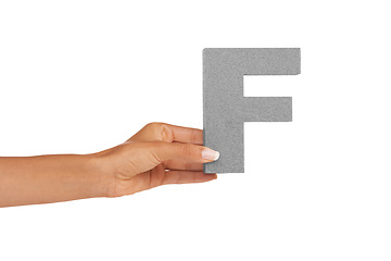 Image showing Hands, capital letter and F in studio for alphabet, font sign or learning english language on white background. Closeup, woman or text design, typography or character of grammar, teaching or spelling