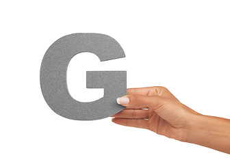 Image showing Hand of woman, capital letter G and presentation of consonant isolated on white background. Character, font and person with English alphabet typeface for communication, reading and writing in studio.