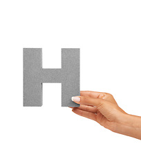 Image showing Hand of woman, capital letter H and presentation of consonant isolated on white background. Character, font and person with English alphabet typeface for communication, reading and writing in studio.