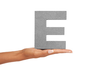 Image showing Hand of woman, capital letter E and presentation of vowel isolated on white background. Character, font and palm showing English alphabet typeface for communication, reading and writing in studio.