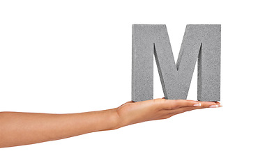 Image showing Woman, hand and letter M or font in studio for advertising, learning or teaching on mock up. Sign, alphabet or character for reading, text or communication and grammar or symbol on white background