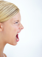 Image showing Angry face, profile or woman screaming in studio at mockup space for crisis, mad emoji or reaction on white background. Frustrated model, voice and shouting loud in anger, negative expression or rage