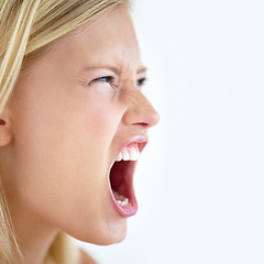 Image showing Angry, face or woman screaming in studio at mockup space for crisis, mad emoji or reaction on white background. Frustrated model, shouting or voice of anger, emotional conflict or negative expression