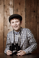 Image showing Binocular, happy and portrait of youth child with equipment for bird watch, exploration or discovery with 1920s fashion. Classic apparel, happiness and young teenager, boy or kid with vintage style