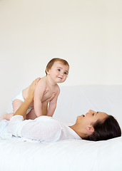 Image showing Happy, baby and mother playing on bed, love and affection or bonding with toddler, smile and connection. Mom, kid and child development at home, care and support or security, motherhood and bedroom