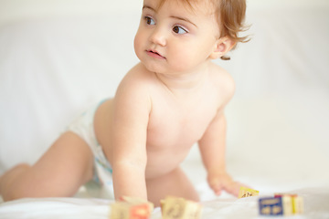 Image showing Baby, building blocks and playing on bed, education and learning for child development in bedroom. Sensory, alphabet and english or letters, care and toys for growth, coordination and cognitive skill