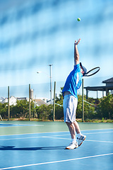 Image showing Tennis match, man and serve in outdoors, competition and playing on court at country club. Athlete, training and exercise or racket for game, performance and practice or cardio workout at stadium