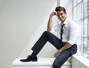 Image showing Smile, fashion and portrait of businessman with formal, elegant and classy outfit by window. Happy, corporate and professional male person with confidence for fancy style sitting in office space.