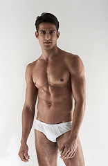 Image showing Portrait, muscle and man with underwear, healthy and confident guy isolated on a white studio background. Person, mockup space and model with body, beauty and wellness with fitness and bodybuilding