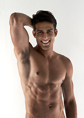 Image showing Muscle, portrait and smile with man, abs and fitness isolated on a white studio background with wellness. Face, person and model with happiness, six pack or bodybuilder with joy, cheerful and healthy