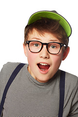 Image showing Portrait, glasses and boy with surprise, announcement and news isolated on a white studio background. Face, person and model with eyewear, hat and shocked with opportunity, facial expression and kid