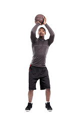 Image showing Man, basketball player and shooting for exercise, training and serious on white background, concentration or game. Studio, young and sportsman for fitness, health and african active athlete